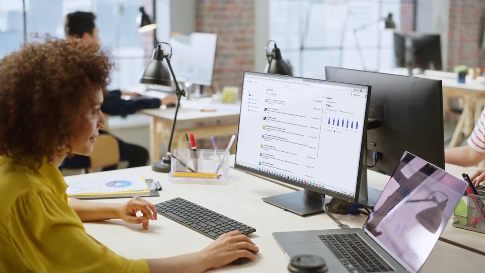 A woman at her desk reviewing a list of tasks her automations have already completed